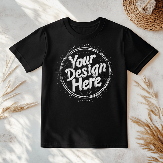 Black t-shirt on rustic wood with “Your Design Here” in white, circular design. Perfect mockup for showcasing custom apparel designs.