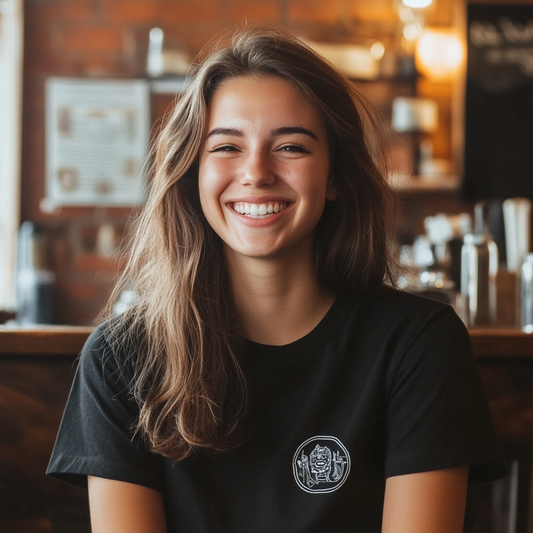 A smiling young woman wearing a custom black t-shirt with a unique graphic design