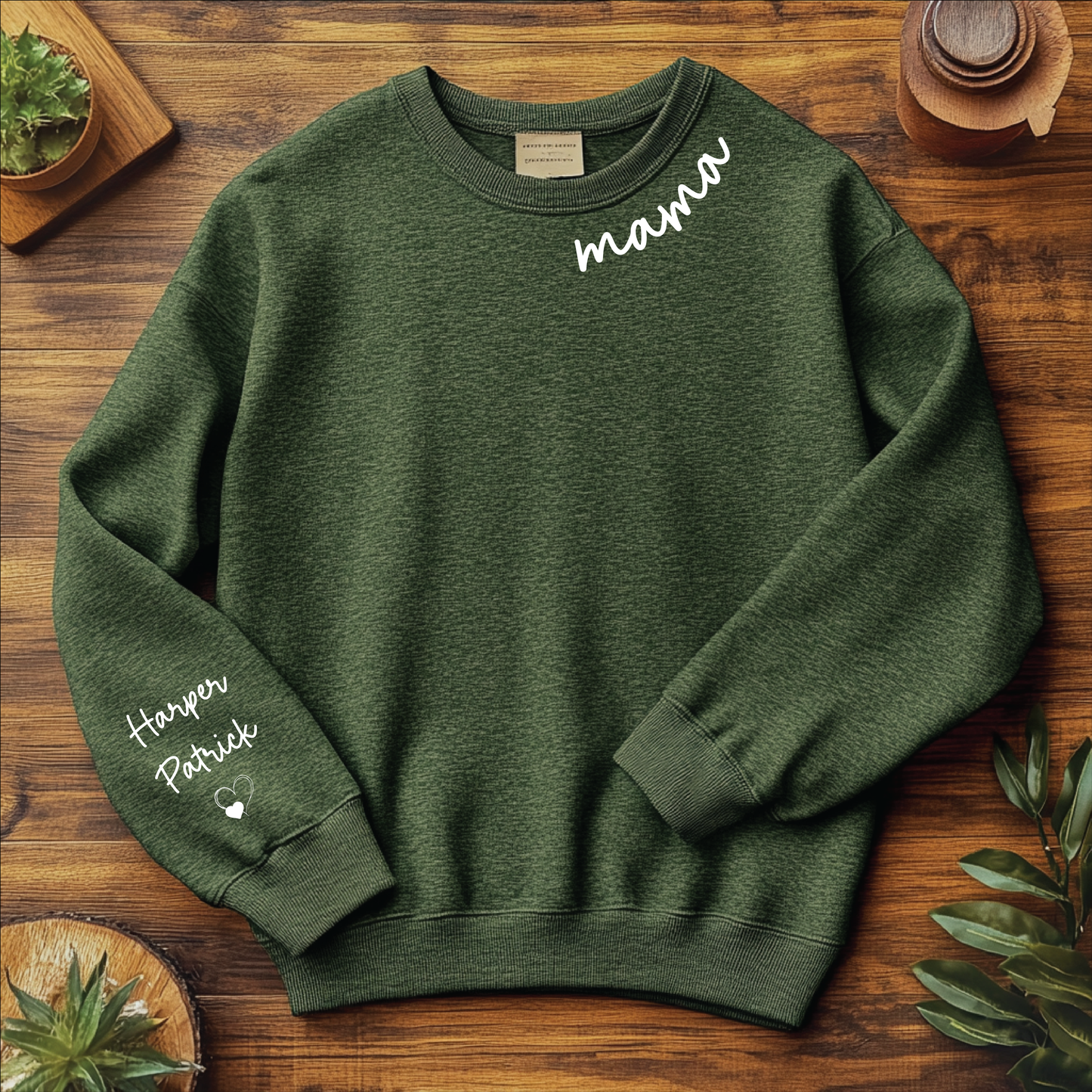 Personalized Mama crewneck in forest green with a stylish script font featuring 'mama' on the neckline and customizable names on the sleeve.