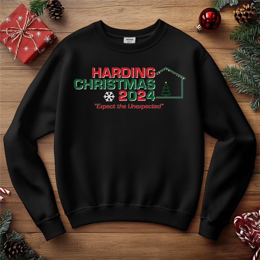 Black sweatshirt with 'Harding Christmas 2024' festive design, featuring holiday lights, snowflakes, and the tagline 'Expect the Unexpected'