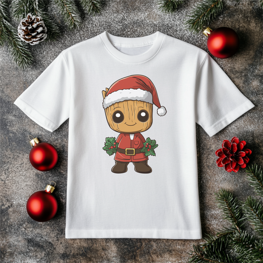 Festive youth shirt with 'I am Christmas' design featuring a holiday character in a Santa hat, displayed on a white shirt with holiday decorations.