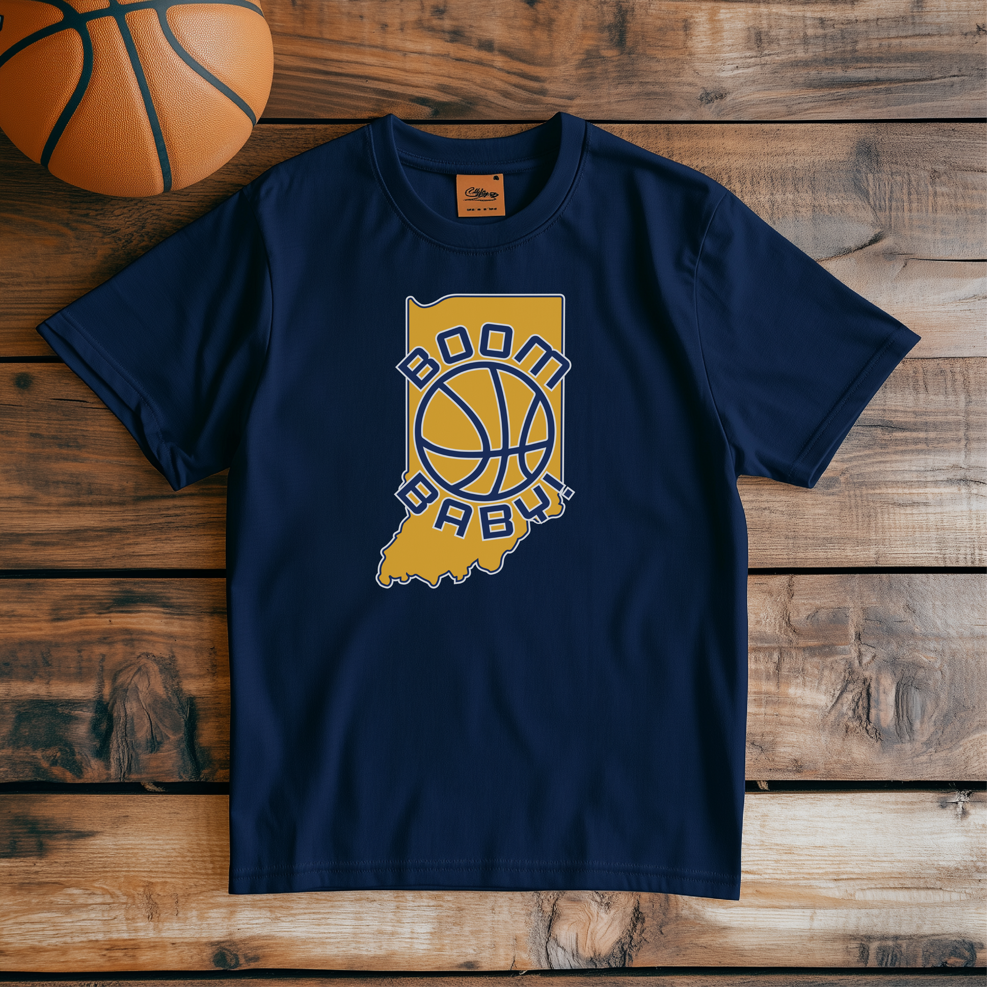 Basketball-themed t-shirt with Indiana state outline, 'Boom Baby!' slogan, and bold basketball graphic. Perfect for Indiana sports fans and basketball enthusiasts. Retro sports-inspired apparel celebrating Indiana's basketball culture on a soft, comfortable tee.