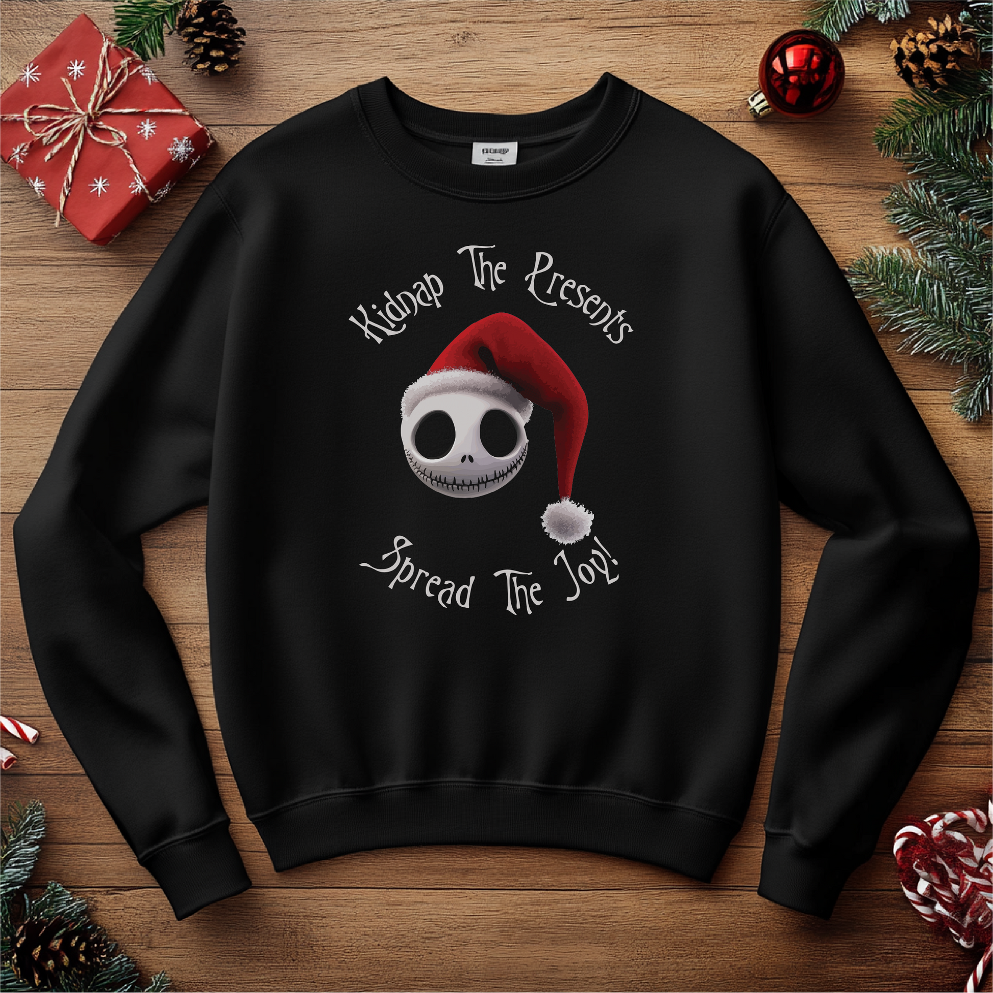 "Kidnap The Presents, Spread The Joy!" holiday design featuring a skull with a Santa hat on a black crewneck sweater, surrounded by festive holiday decor.