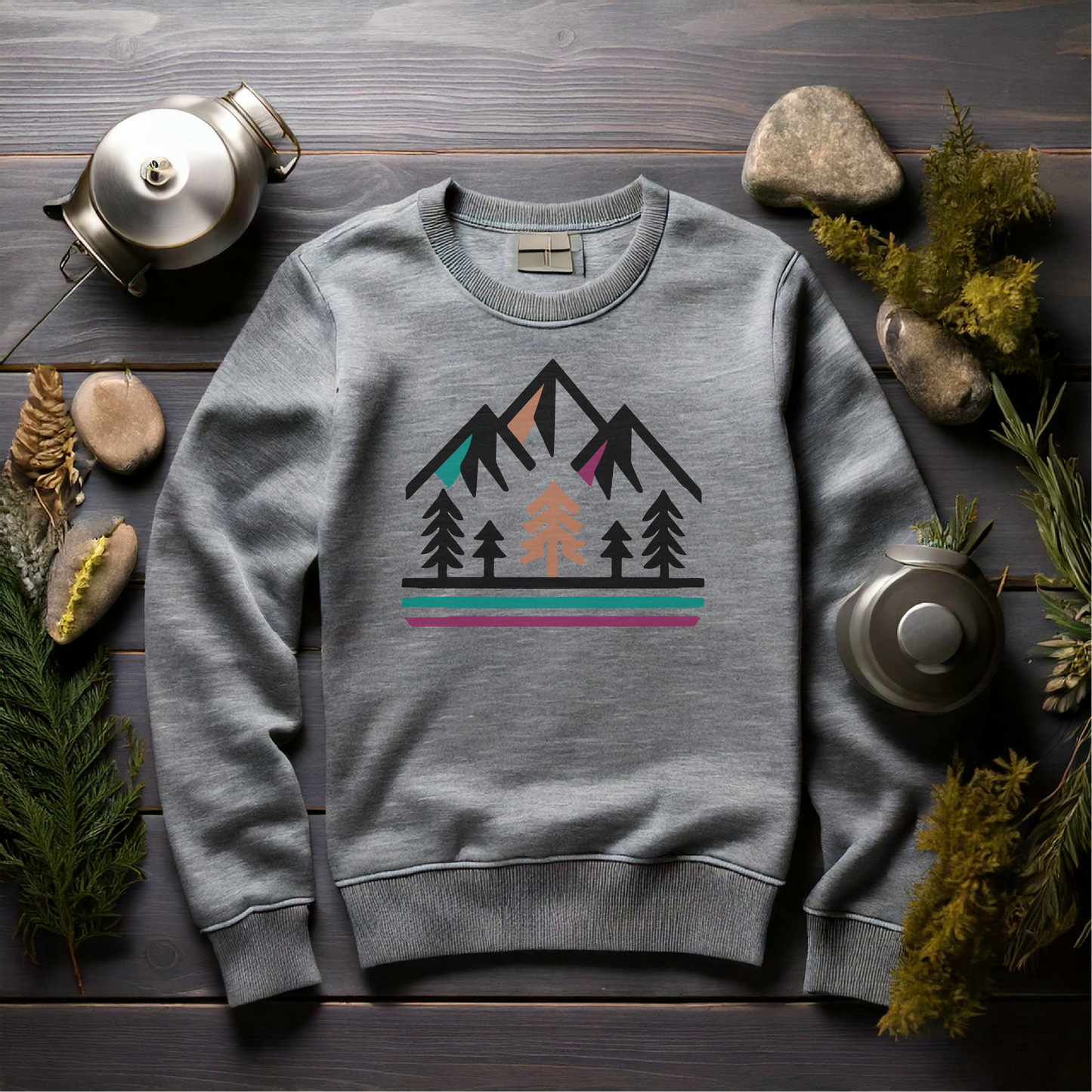 Mountain scene sweatshirt featuring a minimalist design with trees, mountain peaks, and vibrant accent stripes, perfect for nature lovers and outdoor enthusiasts. Cozy adventure-inspired apparel ideal for camping, hiking, and wilderness exploration. Available in multiple shirt styles and colors.