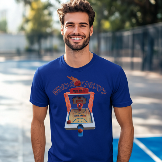 Who Got Next? basketball arcade-themed graphic design on a royal blue t-shirt, modeled outdoors on a basketball court, perfect for retro sports fans.